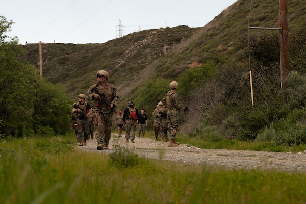 Students of Navy Medicine's first integrated implementation of En-route Care System (ERCS) and Emergency Resuscitative Surgical System (ERSS) undergo combat patrol training, March 13. ERCS and ERSS are components of the Navy’s expeditionary medicine (EXMED) system which provide a ready, rapidly deployable and combat effective medical forces to improve survivability across the full spectrum of care, regardless of environment. and provides uninterrupted care during patient movement from the point of injury (POI), implementation of life-saving interventions, and through Role 4 care without clinically compromising the patients’ condition. The Navy Medicine Operational Training Command (NMOTC) is the Navy’s leader in operational medicine and trains specialty providers for aviation, surface, submarine, expeditionary, and special operations communities. (U.S. Navy photo by Mass Communication Specialist 1st Class Russell Lindsey SW/AW)