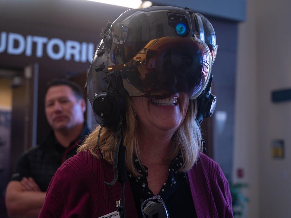 Jennie Thomas, 56th Fighter Wing command chief honorary commander, tries on a decommissioned F-35 Lightning II helmet March, 24, 2023, at Luke Air Force Base, Arizona.