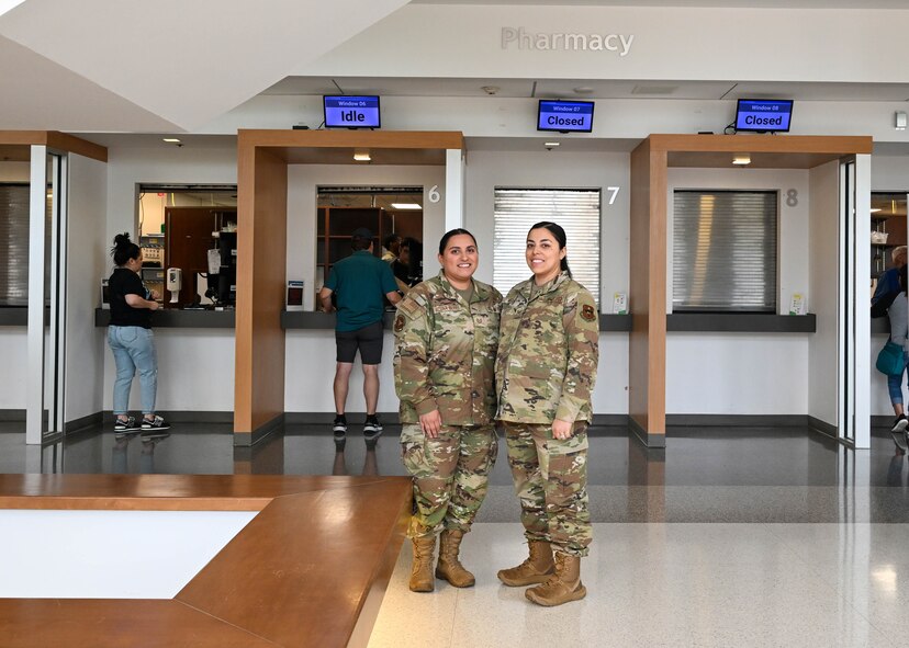 From left to right, Tech. Sgt. Alicia Acuna-Berry, 59th Medical Diagnostic and Therapeutic Squadron Central Fill Pharmacy noncommissioned officer in charge, and her sister, Staff Sgt. Angelina McCoy, 59th Medical Wing staff agency education and training manager, pose for a photo in honor of National Sibling Day at Wilford Hall Ambulatory Surgical Center, Joint Base San Antonio-Lackland, Texas, April 10, 2024. Inspired by her mother's work as a pharmacy technician, Acuna-Berry shared that with the support of her mother, she enrolled in the Delayed Entry Program at the age of 16 and enlisted at 18 years old driven by her own desire to help people and serve her country. (U.S. Air Force photo by Senior Airman Melody Bordeaux)