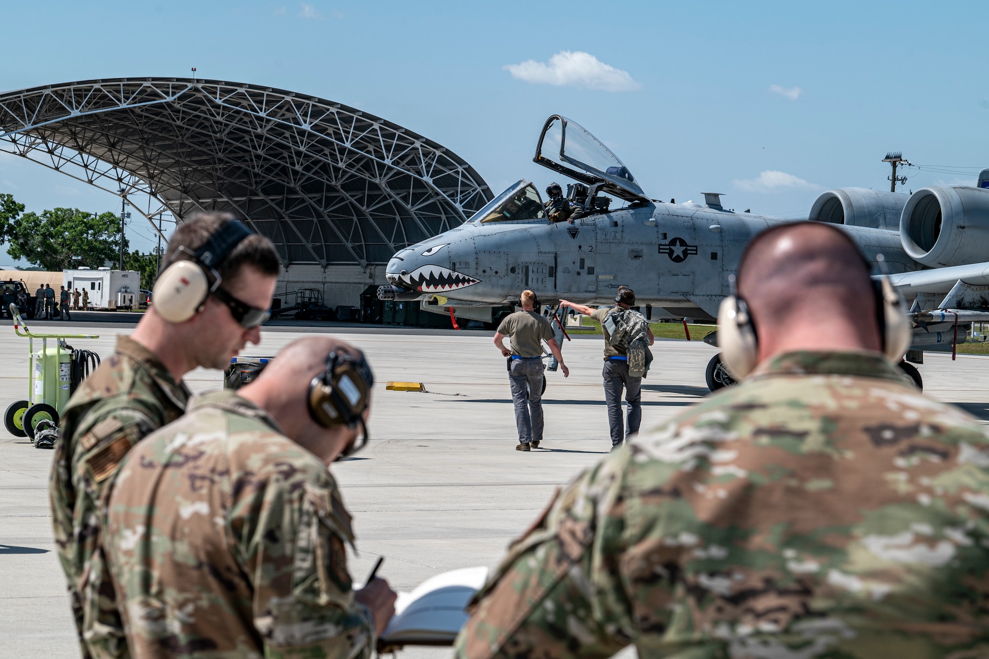 U.S. Air Force Airmen assigned to the 74th Fighter Generation Squadron communicate with an A-10C Thunderbolt II pilot as observers from the 23rd Wing inspection team take notes during Exercise Ready Tiger 24-1 at Avon Park Air Force Range, Florida, April 10, 2024. Inspectors took notes and sent daily performance reports to the main operating base as the exercise progressed. The Ready Tiger 24-1 exercise evaluators will assess the 23rd Wing's proficiency in employing decentralized command and control to fulfill air tasking orders across geographically dispersed areas amid communication challenges. (U.S. Air Force photo by Airman 1st Class Leonid Soubbotine)