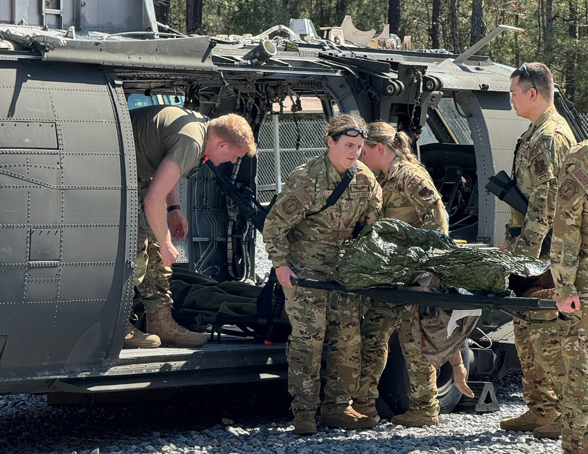 U.S. Air Force Airmen from the 109th Aeromedical Evacuation Squadron offload a simulated patient from a helicopter at Camp Shelby Joint Forces Training Auxiliary Airfield, Hattiesburg, Miss., March 6, 2024.