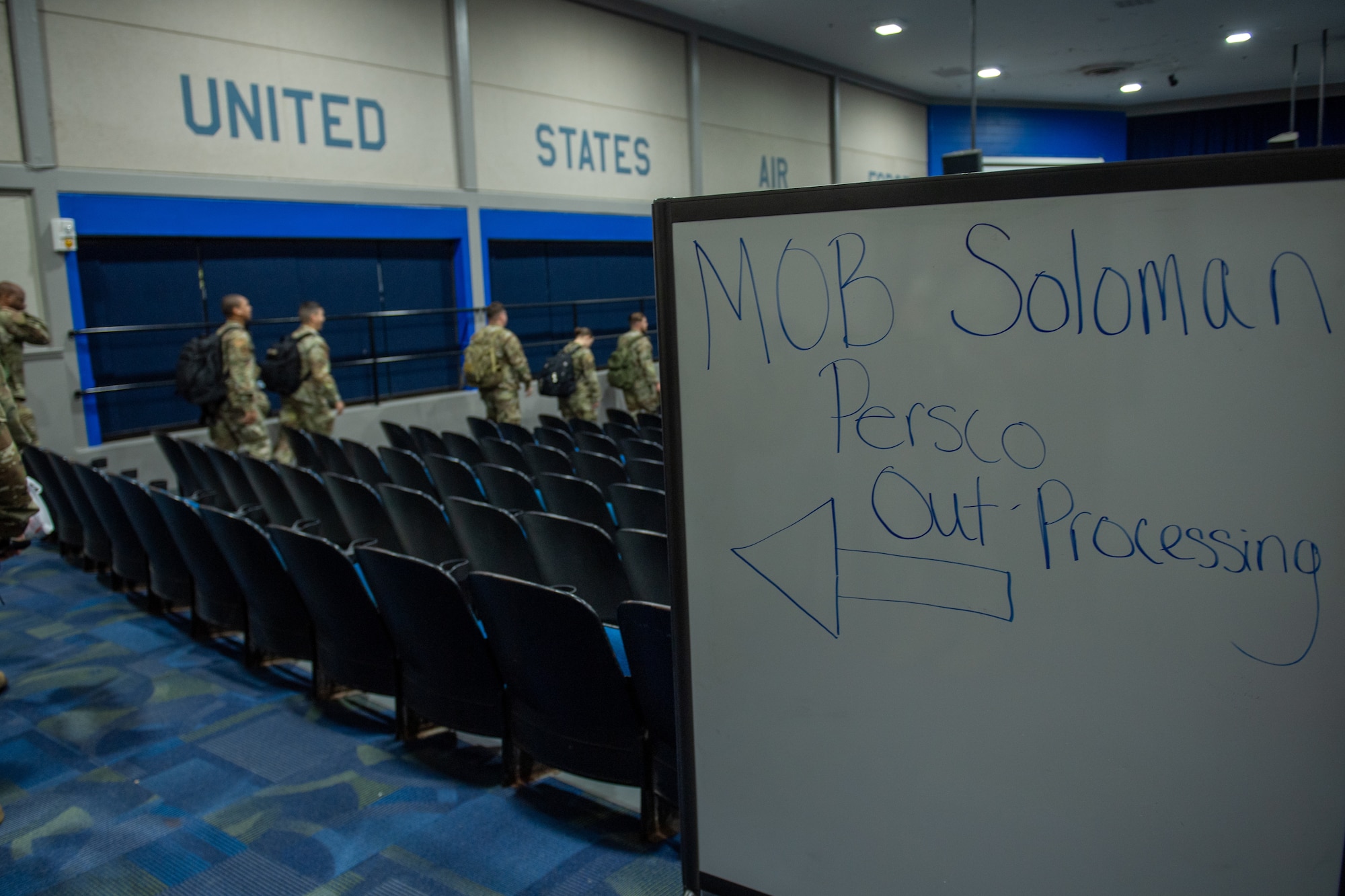 U.S. Air Force Airmen assigned to the 23rd Wing line up at the Hoffman Auditorium to outprocess in preparation for Exercise Ready Tiger 24-1 at Moody Air Force Base, Georgia, April 8, 2024. The outprocessing line ensured personnel were properly equipped with necessary deployment documentation. (U.S. Air Force photo by Airman Cade Ellis)