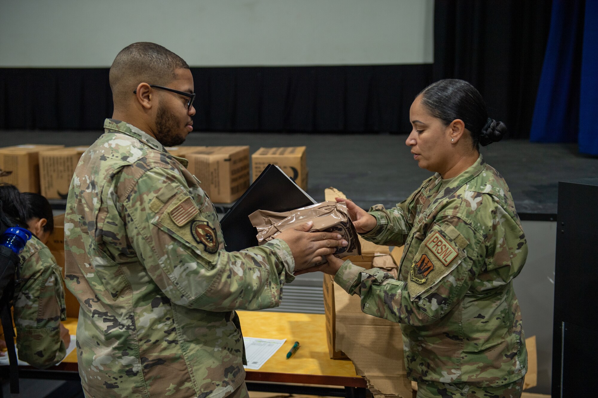 U.S. Air Force Airmen assigned to the 23rd Wing hand out Meals Ready-to-Eat in preparation for Exercise Ready Tiger 24-1 at Moody Air Force Base, Georgia, April 8, 2024. Exercise participants were given MREs which are self-contained operational rations consisting of a full meal packed in a flexible meal bag.  (U.S. Air Force photo by Airman Cade Ellis)