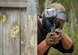 An Eglin Air Force Base, Fla. Airman takes aim at the opposing paintball team behind a barrier wall April 9.   Several Armen participated in mock scenarios during a day of team building, resilience building and connectedness.  (U.S. Air Force photo/Kevin Gaddie)