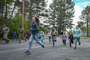 Kids and Airmen run around