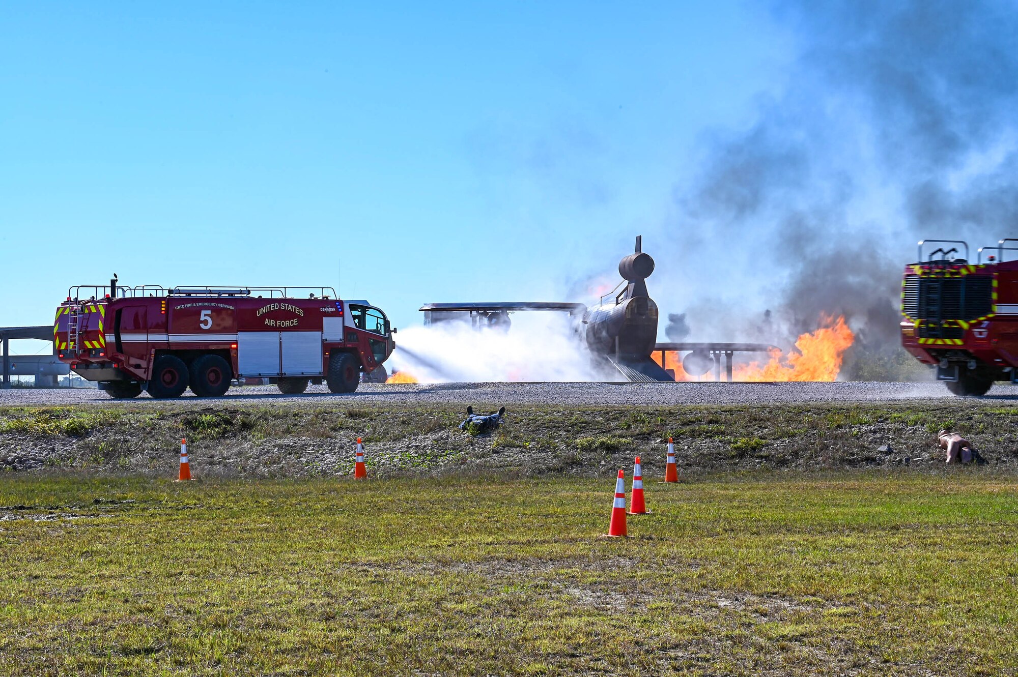 Members of the Combat Readiness Training Center Fire Department work to extinguish a simulated plane crash fire during a disaster exercise at Gulfport-Biloxi International Airport, Gulfport, Mississippi, March 28, 2024.