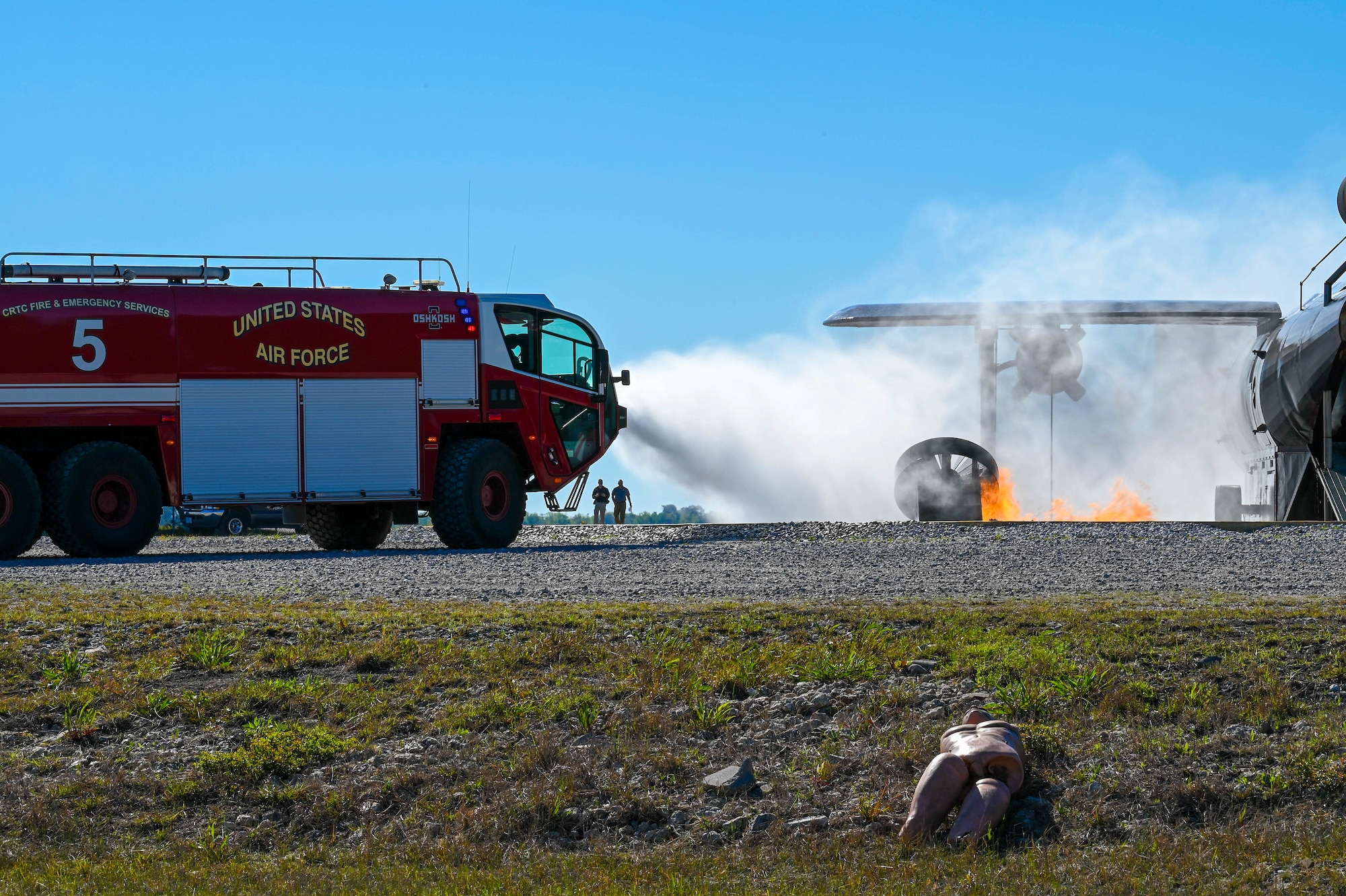 Members of the Combat Readiness Training Center Fire Department work to extinguish a simulated plane crash fire during a disaster exercise at Gulfport-Biloxi International Airport, Gulfport, Mississippi, March 28, 2024.