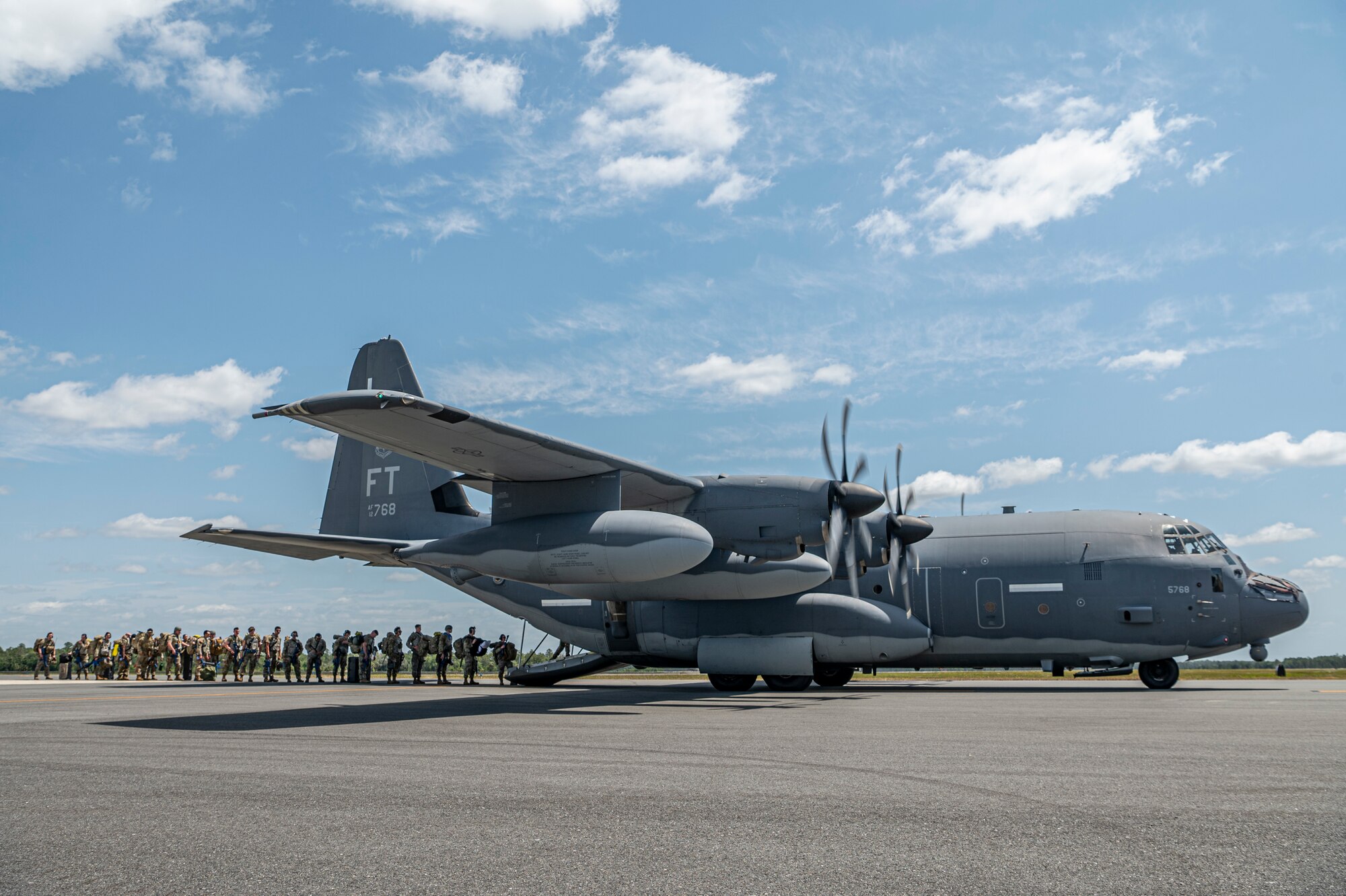 U.S. Air Force Airmen assigned to the 23rd Wing line up to board an HC-130J Combat King II for Exercise Ready Tiger 24-1 at Avon Park Air Force Range, Florida, April 10, 2024. HC-130J aircraft are flexible fixed-wing platforms that enable Airmen to execute transport and combat search and rescue missions. Ready Tiger 24-1 is a readiness exercise demonstrating the 23rd Wing’s ability to plan, prepare and execute operations and maintenance to project air power in contested and dispersed locations, defending the United States’ interests and allies. (U.S. Air Force photo by Airman 1st Class Leonid Soubbotine)