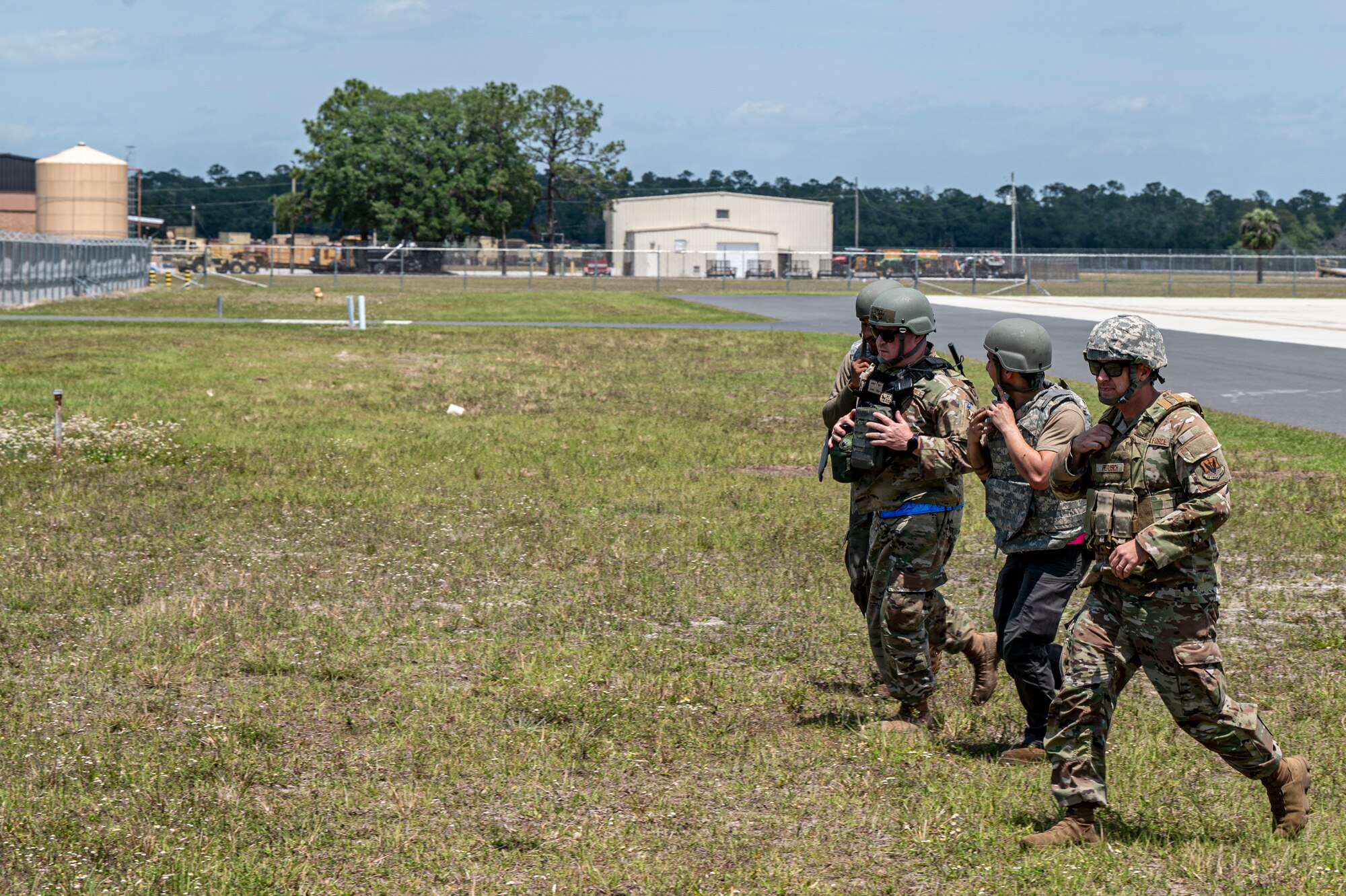 U.S. Air Force Airmen assigned to the 23rd Wing sprint across a field during Exercise Ready Tiger 24-1 at Avon Park Air Force Range, Florida, April 10, 2024. Airmen donned the protective gear in response to an increased simulated threat at an austere contingency location. Ready Tiger 24-1 is a readiness exercise demonstrating the 23rd Wing’s ability to plan, prepare and execute operations and maintenance to project air power in contested and dispersed locations, defending the United States’ interests and allies. (U.S. Air Force photo by Airman 1st Class Leonid Soubbotine)