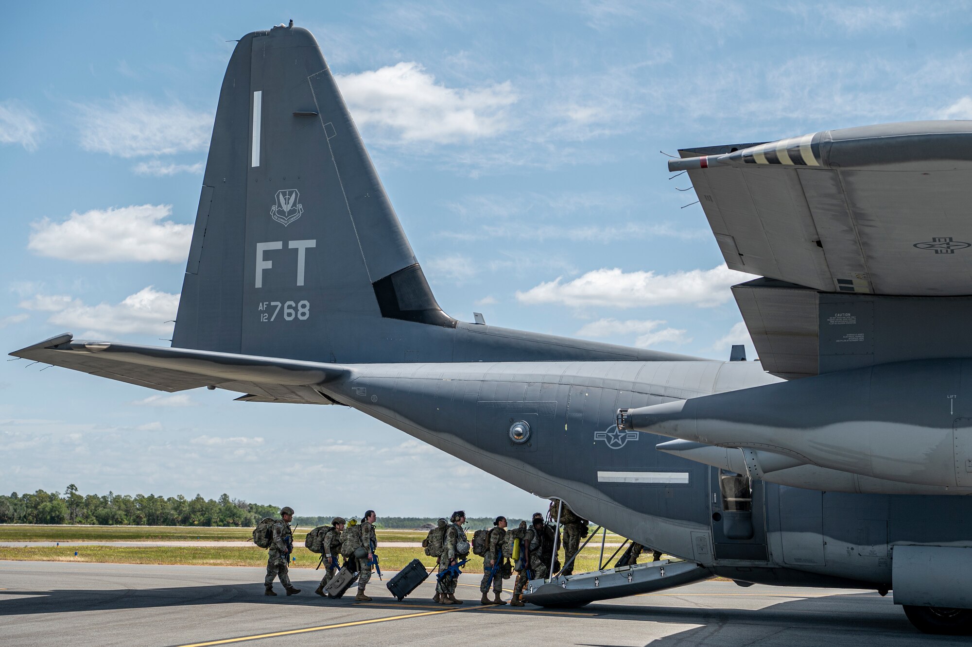 U.S. Air Force Airmen assigned to the 23rd Wing line up to board HC-130J Combat King II for Exercise Ready Tiger 24-1 at Avon Park Air Force Range, Florida, April 10, 2024. HC-130J aircraft are flexible fixed-wing platforms that enable Airmen to execute transport and combat search and rescue missions. Ready Tiger 24-1 is a readiness exercise demonstrating the 23rd Wing’s ability to plan, prepare and execute operations and maintenance to project air power in contested and dispersed locations, defending the United States’ interests and allies. (U.S. Air Force photo by Airman 1st Class Leonid Soubbotine)