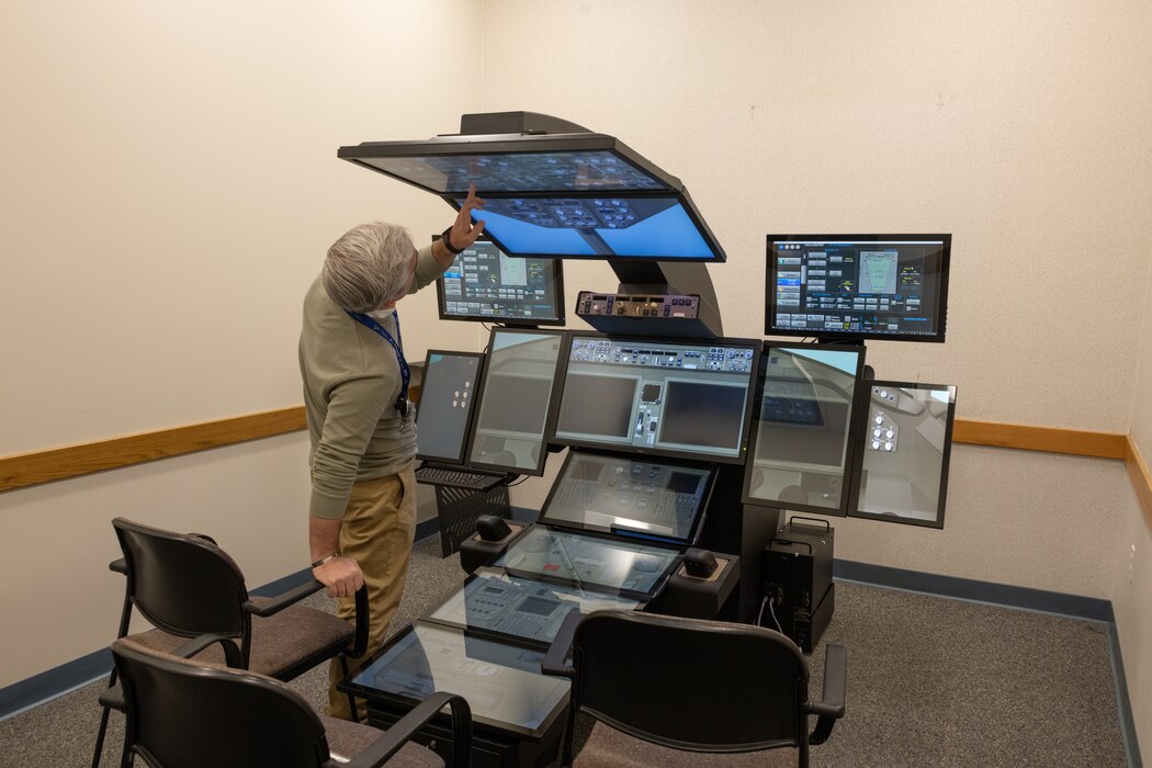 An instructor demonstrates the Pilot Part Task simulator