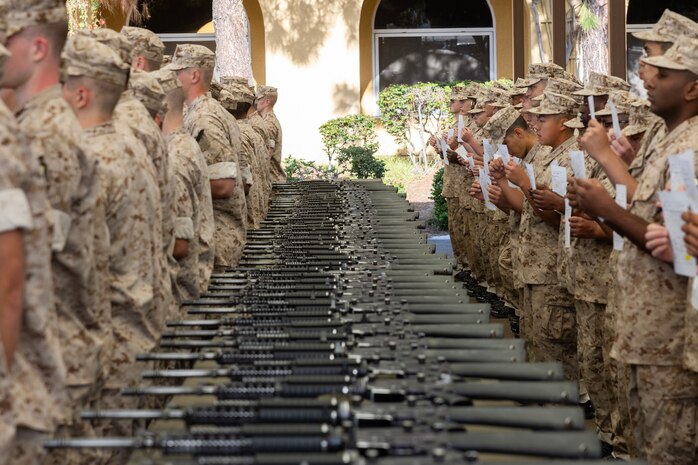 U.S. Marine Corps recruits with Echo Company, 2nd Recruit Training Battalion, await instruction during their M16A4 service rifle issue at Marine Corps Recruit Depot San Diego, California, April 8, 2024. Recruits were issued their rifles and briefed on responsibilities regarding rifle security, safety and proper handling. (U.S. Marine Corps photo by Cpl. Alexander O. Devereux)