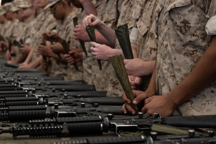 U.S. Marine Corps recruits with Echo Company, 2nd Recruit Training Battalion, inventory their new gear during a M16A4 service rifle issue at Marine Corps Recruit Depot San Diego, California, April 8, 2024. Recruits were issued their rifles and briefed on responsibilities regarding rifle security, safety and proper handling. (U.S. Marine Corps photo by Cpl. Alexander O. Devereux)