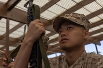 U.S. Marine Corps Recruit Jun Young Kim, with Echo Company, 2nd Recruit Training Battalion, receives instructions during M16A4 service rifle issue at Marine Corps Recruit Depot San Diego, California, April 8, 2024. Recruits were issued their rifles and briefed on responsibilities regarding rifle security, safety and proper handling. (U.S. Marine Corps photo by Cpl. Alexander O. Devereux)