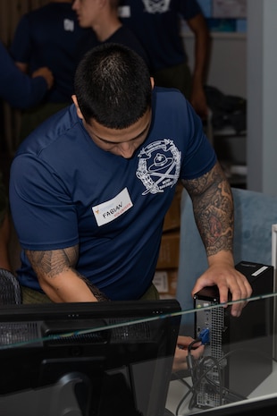 U.S. Marine Corps Sgt. Fabian Aguilar, a drill instructor with India Company, 3rd Recruit Training Battalion, assembles a computer during a volunteer event at a Ronald McDonald House in San Diego, California, April 8, 2024. The Ronald McDonald House provides a home away from home at no cost for families with sick and injured children, ages 21 and younger. (U.S. Marine Corps photo by Lance Cpl. Janell B. Alvarez)