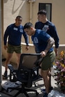 U.S. Marine Corps Sgt. Rafael Garcia, left, Sgt Joseph Zerener, in between, Sgt. Fabian Aguilar, foreground, all drill instructors with India Company, 3rd Recruit Training Battalion, move chairs during a volunteer event at a Ronald McDonald House in San Diego, California, April 8, 2024. The Ronald McDonald House provides a home away from home at no cost for families with sick and injured children, ages 21 and younger. (U.S. Marine Corps photo by Lance Cpl. Janell B. Alvarez)