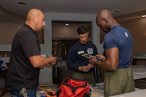 U.S. Marine Corps Sgt. Nater Ronald, center, and Sgt. Victor Obakpe, right, both drill instructors with India Company, 3rd Recruit Training Battalion, sort tools during a volunteer event at a Ronald McDonald House in San Diego, California, April 8, 2024. The Ronald McDonald House provides a home away from home at no cost for families with sick and injured children, ages 21 and younger. (U.S. Marine Corps photo by Lance Cpl. Janell B. Alvarez)