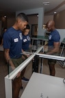 U.S. Marine Corps Sgt. Cole Simon, left, Sgt Fabian Aguilar, center, Sgt. Victor Obakpe, right, drill instructors with India Company, 3rd Recruit Training Battalion, assemble furniture during a volunteer event at a Ronald McDonald House in San Diego, California, April 8, 2024. The Ronald McDonald House provides a home away from home at no cost for families with sick and injured children, ages 21 and younger. (U.S. Marine Corps photo by Lance Cpl. Janell B. Alvarez)