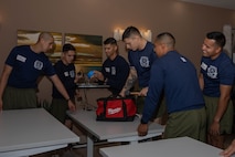 U.S. Marine Corps drill Instructors with India Company, 3rd Recruit Training Battalion, sort through a tool-bag during a volunteer event at a Ronald McDonald House in San Diego, California, April 8, 2024. The Ronald McDonald House provides a home away from home at no cost for families with sick and injured children, ages 21 and younger. (U.S. Marine Corps photo by Lance Cpl. Janell B. Alvarez)
