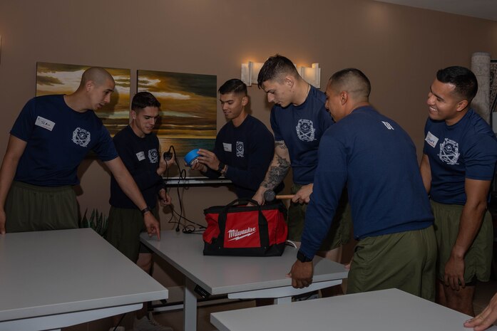 U.S. Marine Corps drill Instructors with India Company, 3rd Recruit Training Battalion, sort through a tool-bag during a volunteer event at a Ronald McDonald House in San Diego, California, April 8, 2024. The Ronald McDonald House provides a home away from home at no cost for families with sick and injured children, ages 21 and younger. (U.S. Marine Corps photo by Lance Cpl. Janell B. Alvarez)