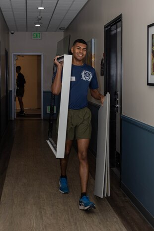 U.S. Marine Corps Sgt. Cole Simon, a drill instructor with India Company, 3rd Recruit Training Battalion, moves furniture during a volunteer event at a Ronald McDonald House in San Diego, California, April 8, 2024. The Ronald McDonald House provides a home away from home at no cost for families with sick and injured children, ages 21 and younger. (U.S. Marine Corps photo by Lance Cpl. Janell B. Alvarez)