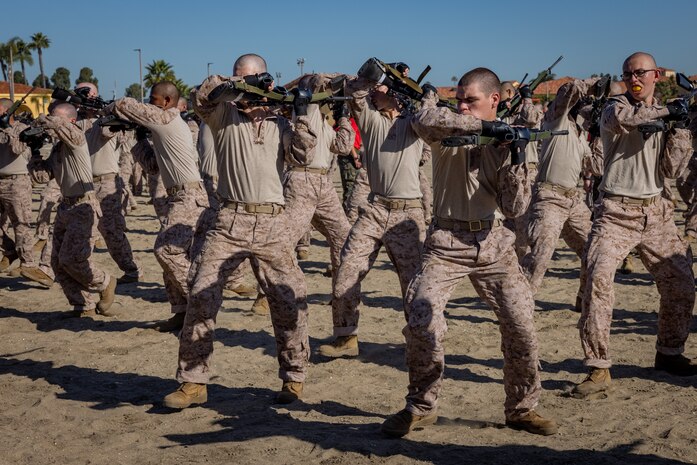 U.S. Marine Corps recruits with Bravo Company, 1st Recruit Training Battalion, practice bayonet techniques prior to the bayonet assault course at Marine Corps Recruit Depot, San Diego, California, April 10, 2024. Bayonet techniques tie into the Marine Corps Martial Arts Program that aims to strengthen the mental and moral resiliency of individual recruits and Marines through realistic combative training, warrior ethos studies, and physical hardening. (U.S. Marine Corps photo by Lance Cpl. Jacob B. Hutchinson)