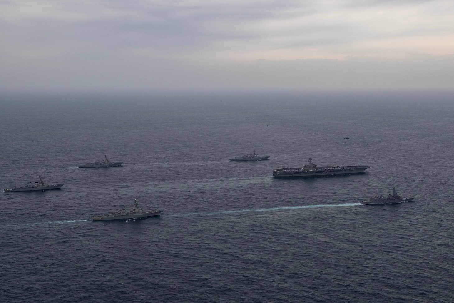 Ships assigned to the Theodore Roosevelt Carrier Strike Group, Japan Maritime Self-Defense Force and Republic of Korea Navy sail in formation during a trilateral exercise, April 11, 2024. This trilateral exercise allowed maritime forces from Japan, the Republic of Korea, and U.S. to train together to enhance coordination on maritime domain awareness and other shared security interests. The Theodore Roosevelt Carrier Strike Group is deployed to the U.S. 7th Fleet area of operations in support of a free and open Indo-Pacific. (U.S. Navy photo by Mass Communication Specialist 1st Class Tommy Gooley)