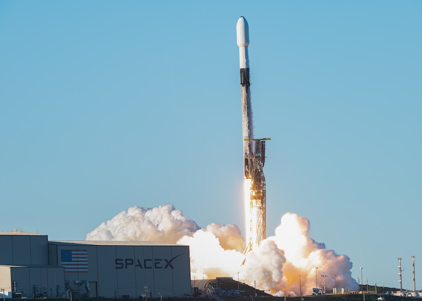 A rocket launches leaving behind clouds of smoke.