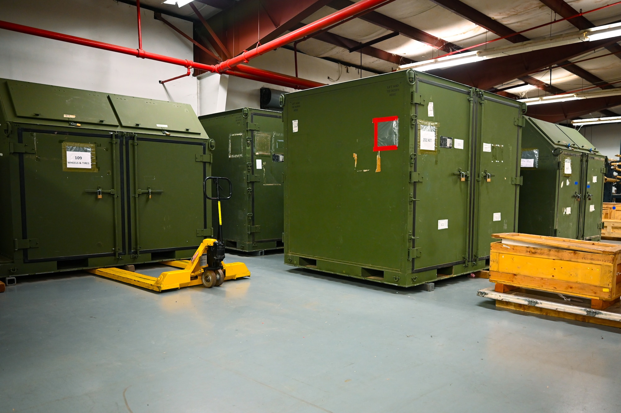 Four big green containers are centered.