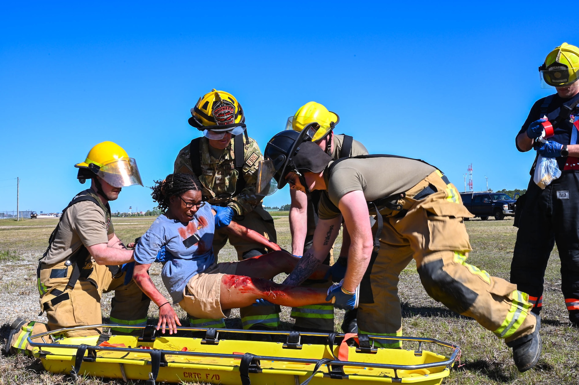 Members of the Combat Readiness Training Center Fire Department, Harrison County Fire Department and Gulfport Fire Department render aid to simulated victims during a disaster exercise at Gulfport-Biloxi International Airport, Gulfport, Mississippi, March 28, 2024.