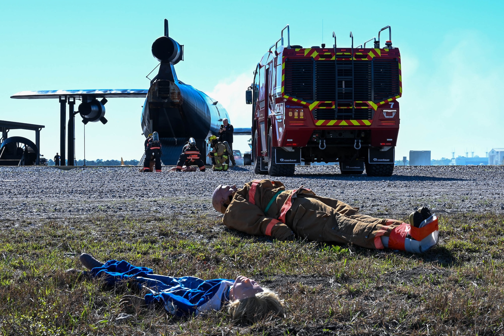 Members of the Combat Readiness Training Center Fire Department, Harrison County Fire Department and Gulfport Fire Department work to extract mannequins representing victims from a simulated plane during a disaster exercise at Gulfport-Biloxi International Airport, Gulfport, Mississippi, March 28, 2024.