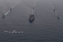 Ships assigned to the Theodore Roosevelt Carrier Strike Group, Japan Maritime Self-Defense Force and Republic of Korea Navy with aircraft assigned to Carrier Air Wing (CVW) 11 sail and fly in formation during a trilateral exercise, April 11, 2024. This trilateral exercise allowed maritime forces from Japan, the Republic of Korea, and U.S. to train together to enhance coordination on maritime domain awareness and other shared security interests. The Theodore Roosevelt Carrier Strike Group is deployed to the U.S. 7th Fleet area of operations in support of a free and open Indo-Pacific. (U.S. Navy photo by Mass Communication Specialist 1st Class Tommy Gooley)