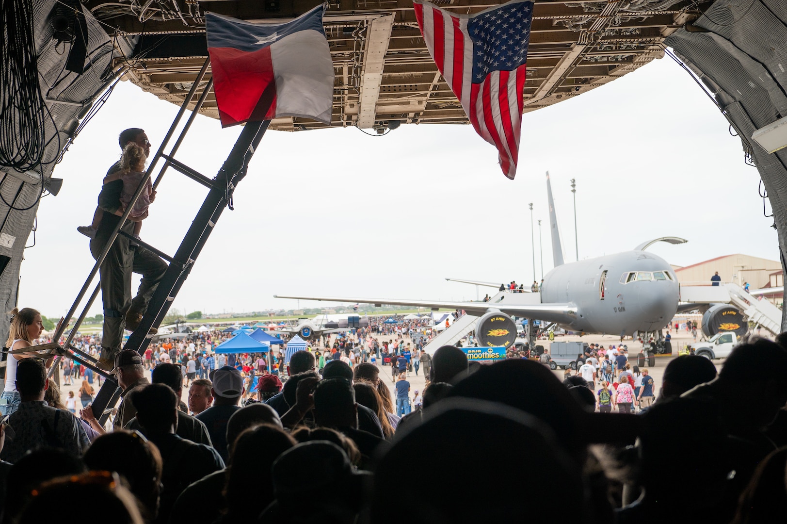 The Great Texas Airshow attendees exit from the 433rd Airlift Wing’s C-5M Super Galaxy as Capt. Britt Talbott, 68th Airlift Squadron pilot, carries his three-year-old daughter up the steps toward the cockpit at Joint Base San Antonio-Randolph, Texas Apr. 7, 2024.