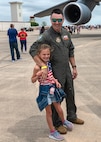 Maj. Gary Koivisto, 433rd Operations Support Squadron instructor pilot, poses for a picture with his daughter at The Great Texas Airshow at Joint Base San Antonio-Randolph, Texas Apr. 7, 2024.