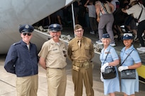 Members of the Airman Heritage Foundation, Senior Airman Zachary Harvill, far left, 502nd Comptroller Squadron financial operations technician, retired Air Force Maj. Allen Vickrey, center left, Tech. Sgt. Sean Harbin, center, 433rd Logistic Readiness Squadron logistics planner, retired Staff Sgt. Sherry Chadwick, center right, and Staff Sgt. Nittara Gage, far right, 189th Medical Group medic, dressed up in legacy uniforms to recognize the military members of the past, and emphasize to the community the importance of remembering history at The Great Texas Airshow at Joint Base San Antonio-Randolph, Texas Apr. 7, 2024.