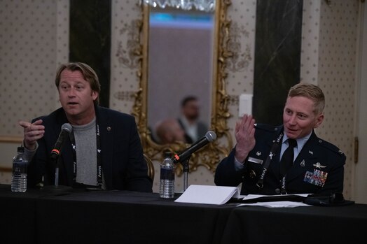  Nicholas Skytland, NASA Johnson Space Center chief technologist and the Business Development and Technology Integration Office director, and U.S. Space Force Col. Christopher A. Kennedy, Space Delta 6 - Space Access and Cyberspace Operations commander, engage with members of the audience during a panel.