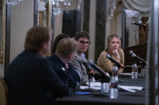  Photo of Outer Space to Cyber Space luncheon panelists engaging with one another.