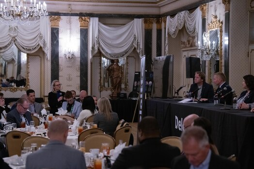  An audience member asks Outer Space to Cyber Space luncheon panelists a question.
