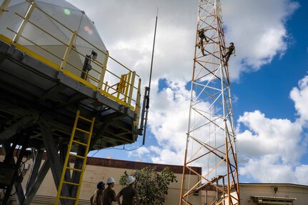 Troops climb a tower.