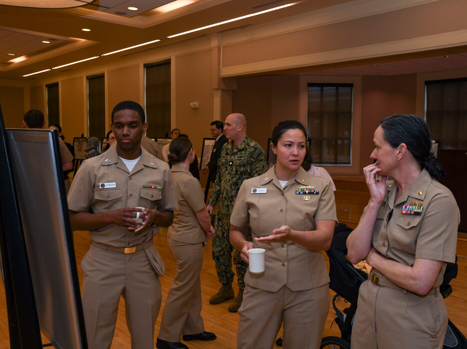 Attendees of the Navy Medical Center Camp Lejeune (NMCCL) Research Symposium view medical research poster presentations, at Marston Pavilion on Marine Corps Base Camp Lejeune on April 11, 2024. This is the 14th Annual Research Symposium hosted by NMCCL when research is showcased across a broad spectrum of medical and non-medical personnel such as corpsmen, nurses, medical students, residents, and more.
