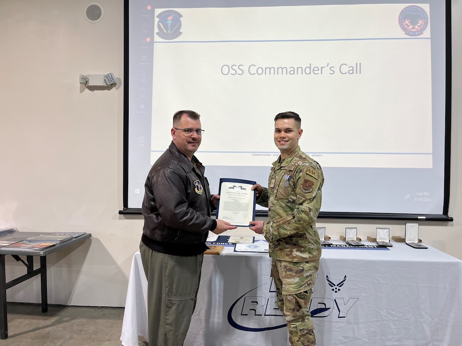 Staff Sergeant Miguel Rodriguez Peraza, right, receives the Air and Space Achievement Medal from Lt Col Joshua Hamm, commander, 174th Operations Support Squadron, during a ceremony March 8, 2024.