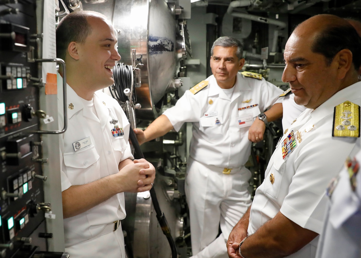 Chief Torpedoman Doug Card, left, speaks to U.S., allied and partner nation submarine force commanders in the torpedo room during a tour aboard the Virginia-class fast-attack submarine USS Delaware (SSN 791) during the third annual Submarine Conference of the Americas (SCOTA) at Fort Lauderdale, Florida, April 3, 2024.