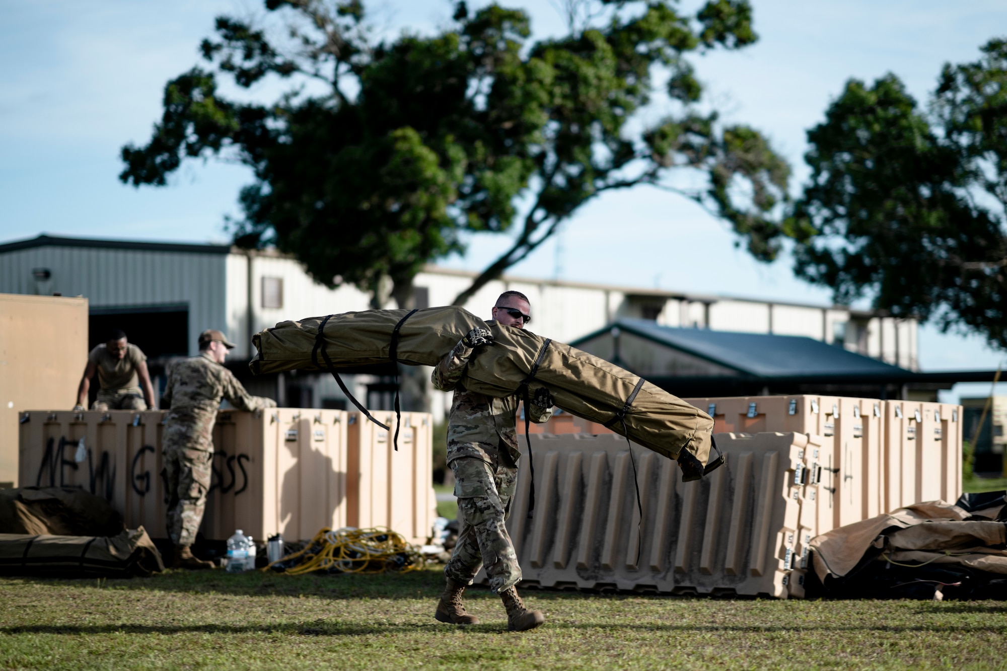 U.S. Air Force Airmen assigned to various units from Moody Air Force Base, Georgia, unload tent equipment from crates at Avon Park Air Force Range, Florida, April 8, 2024. The 23rd Civil Engineer Squadron solicited help from Airmen in various career fields to establish shelters for the exercise. Built upon Air Combat Command's directive to assert air power in contested environments, exercise Ready Tiger 24-1 aims to test and enhance the 23rd Wing’s proficiency in executing Lead Wing and expeditionary air base concepts through Agile Combat Employment and command and control operations. (U.S. Air Force photo by Tech. Sgt. Devin Boyer)