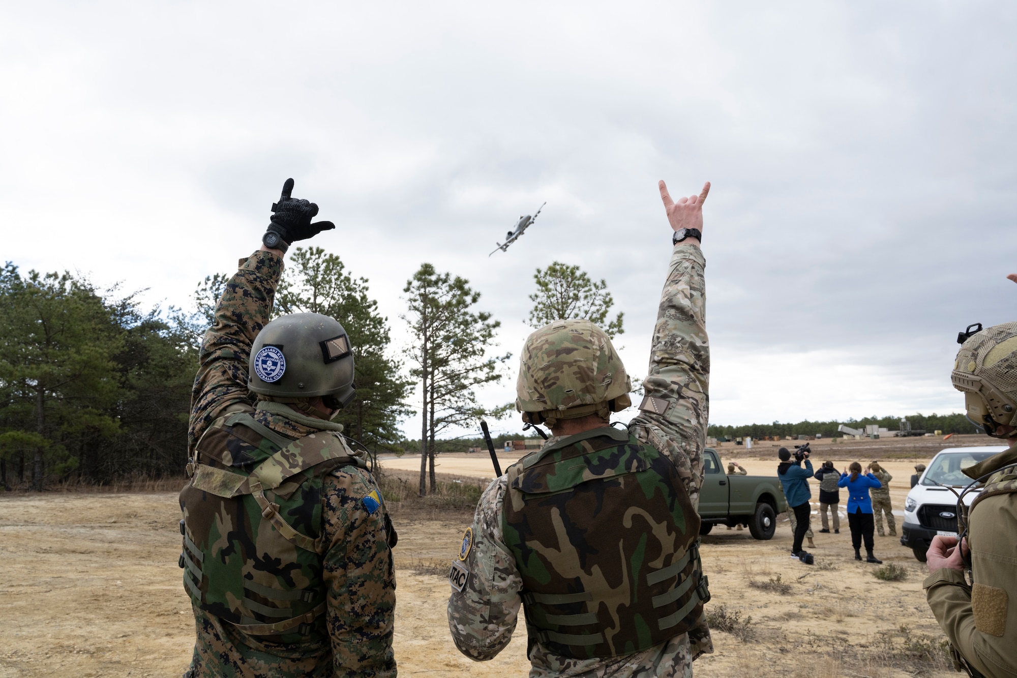 Joint Terminal Attack Controllers from the Armed Forces of Bosnia and Herzegovina gesture to an A-10C Thunderbolt II pilot during Deliberate Response '24, April 6, 2024, at Warren Grove Range, NJ.