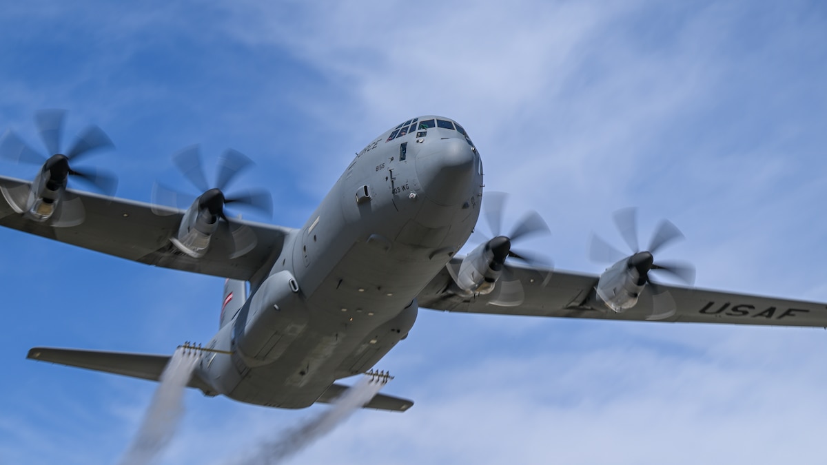 A C-130J-30 Super Hercules from Keesler Air Force Base, Miss., sprays water during a low pass at Youngstown Air Reserve Station, Ohio, March 25, 2024, as part of a flight test of the 910th Airlift Wing's unique electronic modular aerial spray system. The 910th AW performs these tests to ensure the operability of the spray system aboard the airframe as it prepares to upgrade its aging C-130H Hercules fleet to new J-models. (U.S. Air Force photo by Eric M. White)