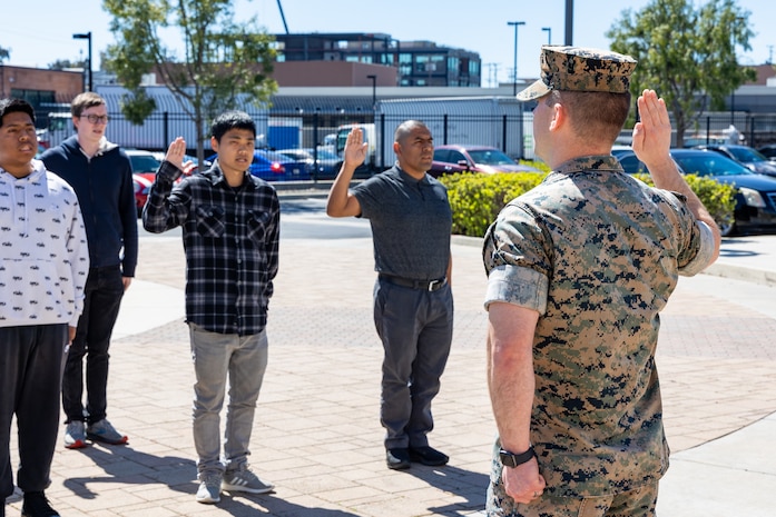 U.S. Marine Corps Capt. Timothy Bowman, the Los Angeles Military Entrance Processing Station operations officer, administers the oath of enlistment to applicants enlisting into the U.S. Armed Forces at the LA MEPS in El Segundo, Calif., April 1. The Marine Corps, in collaboration with the United States Citizenship and Immigration Services, have reinstated the expedited naturalization program in order to provide qualified recruits the opportunity to become naturalized U.S. citizens upon completion of recruit training. (U.S. Marine Corps photo by Staff Sgt. Courtney G. White)