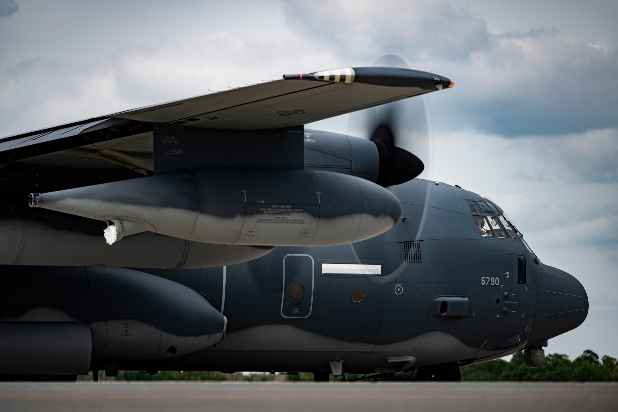 U.S. Air Force pilots assigned to the 71st Rescue Squadron park an HC-130J Combat King II for a personnel and cargo offload at Avon Park Air Force Range, Florida, April 9, 2024. Airmen forward deployed to Avon Park to participate in exercise Ready Tiger 24-1, establishing an airfield in a simulated austere environment. During Ready Tiger 24-1, exercise inspectors will assess the 23rd Wing's proficiency in employing decentralized command and control to fulfill air tasking orders across geographically dispersed areas amid communication challenges, integrating Agile Combat Employment principles such as integrated combat turns, forward aerial refueling points, multi-capable Airmen, and combat search and rescue capabilities. (U.S. Air Force photo by Tech. Sgt. Devin Boyer)