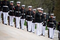 Marines in ceremonial uniforms are lined up on steps that lead up to the Tomb of the Unknown Soldier.