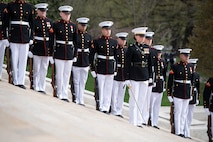 Marines in ceremonial uniforms are lined up on steps that lead up to the Tomb of the Unknown Soldier.