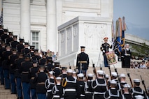 An Army drummer play at the base of the Tomb of the Unknown Soldier while dozens of soldiers from all branches march up the steps.